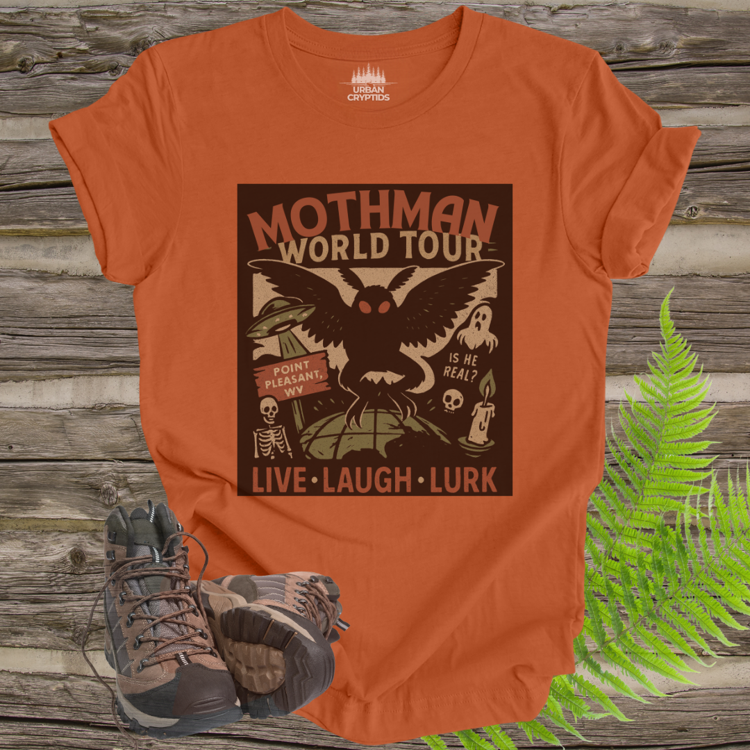 Orange t-shirt with Mothman graphic design on a wooden background