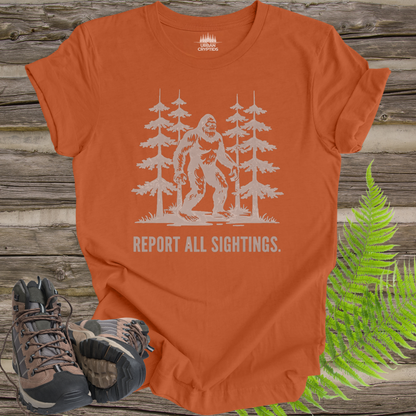 Bigfoot “Report All Sightings” T-Shirt – Vintage Cryptid Forest Design