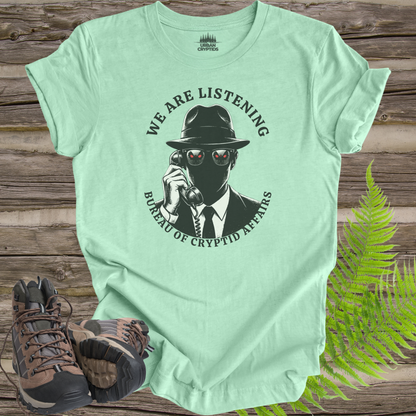 We Are Listening – Bureau of Cryptid Affairs Tee